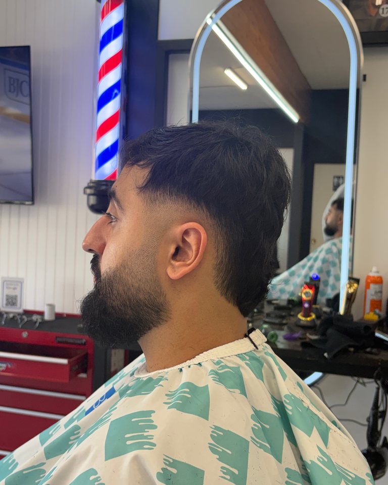 Profile of a fresh fade and shaped full beard