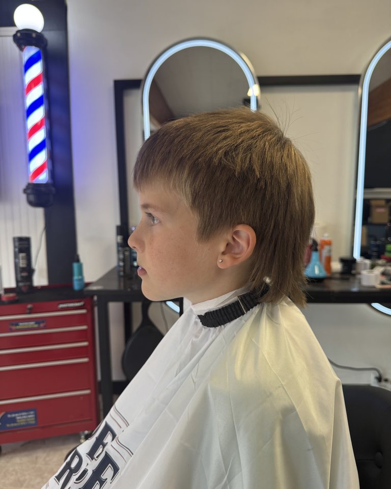 A young customer’s longer fringe before a haircut