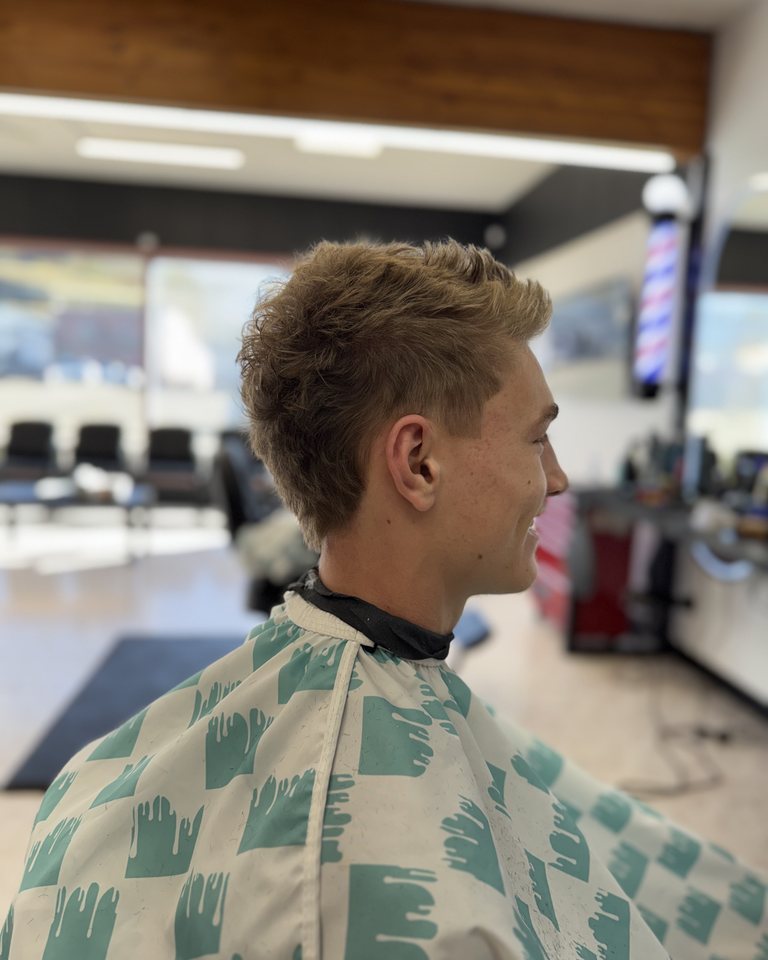 Curly textured top with neatly tapered sides
