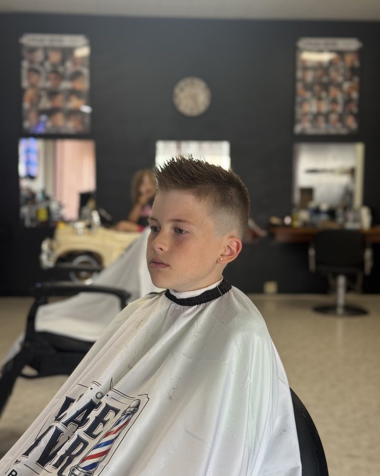 Front view showing the shape and finish of a short kids haircut