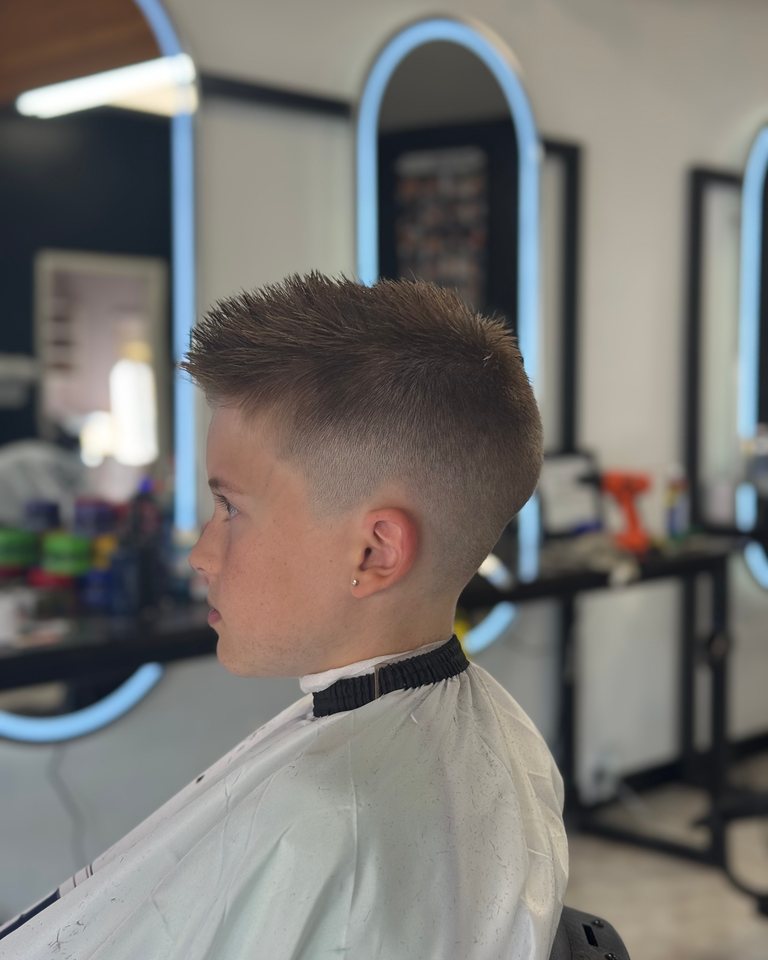 Kids haircut with a neat fade around the ear