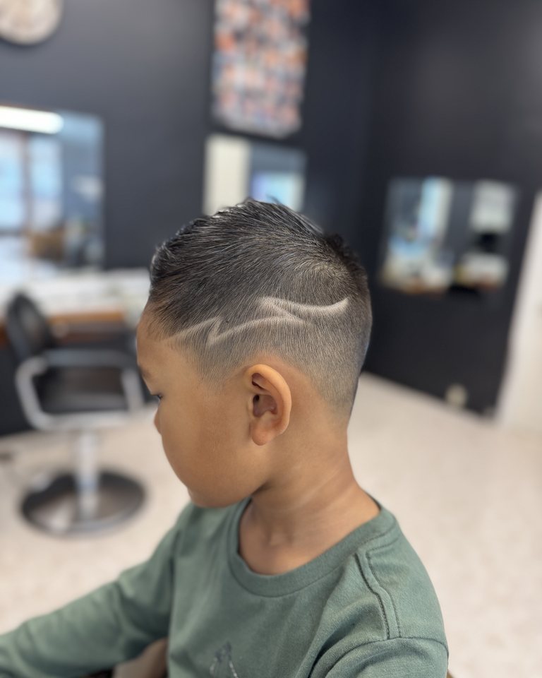 Kids haircut with a curved shaved design