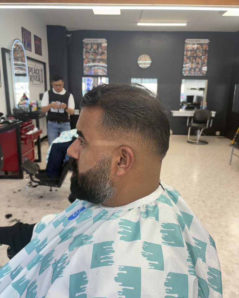 Close side view of a finished fade and beard