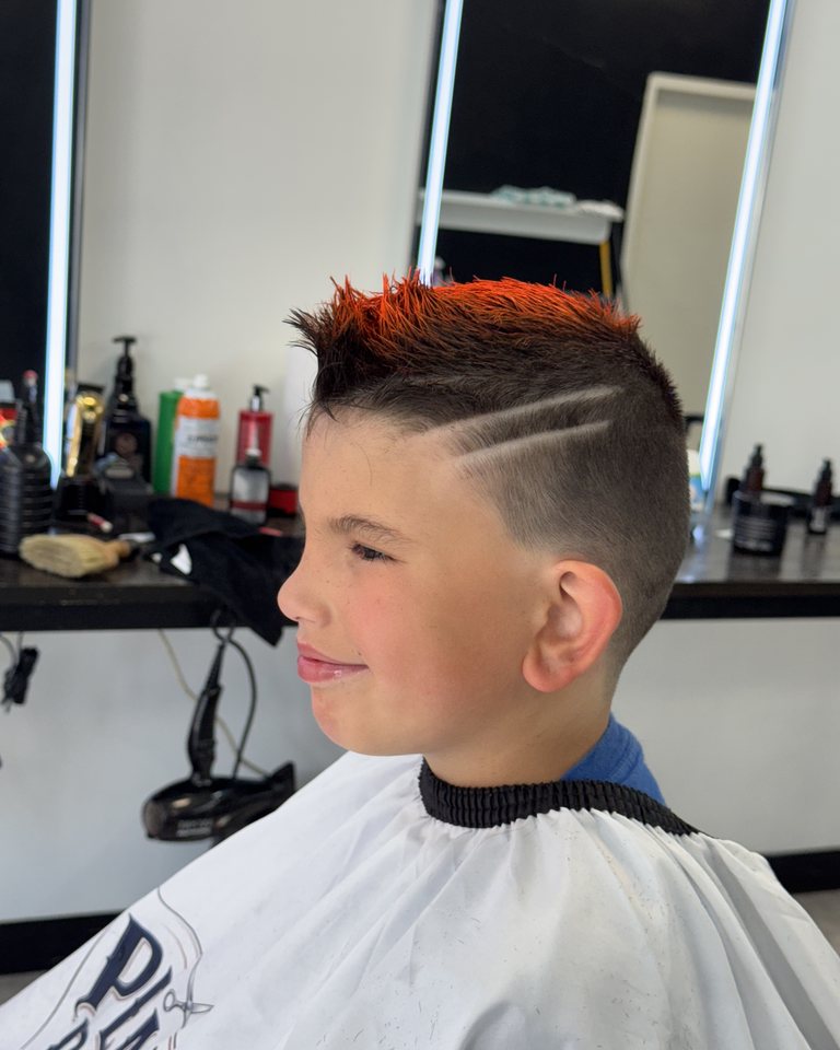 Textured kids haircut with a shaved line design