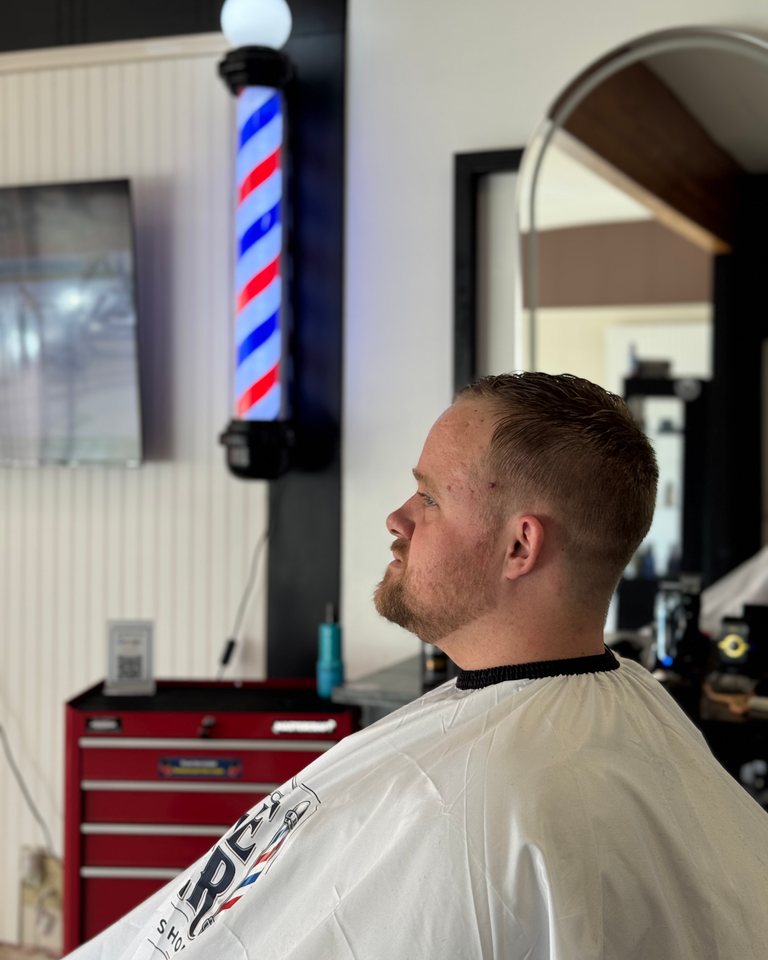 Textured short haircut with closely tapered sides