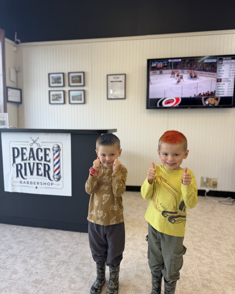 Two young visitors standing together inside the shop