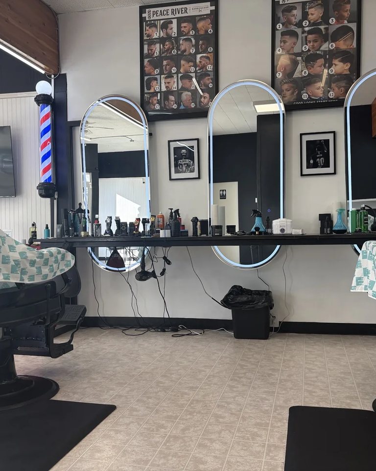 Barber chairs and arched mirrors inside the shop