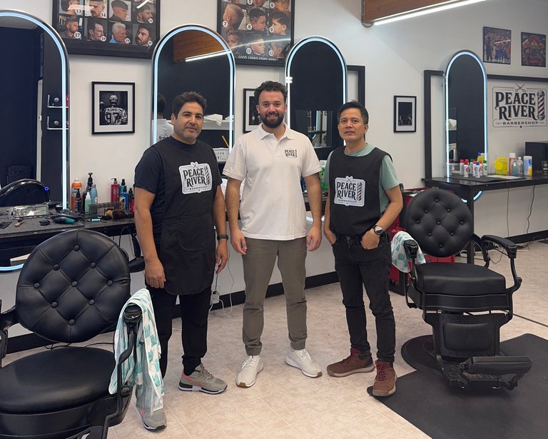 The Peace River Barbershop team together between the barber chairs